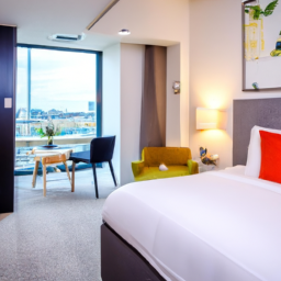the vibrant essence of Staybridge Suites London-Vauxhall, an IHG Hotel, with an image showcasing a stunning riverside view from the hotel's spacious and modern suites, adorned with cozy furnishings and contemporary decor